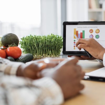 nutrition expert pointing at eating data on device at work nutrition expert pointing at eating data on device at work