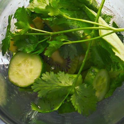 top view blender start mixing vegetables herbs in super slow mot